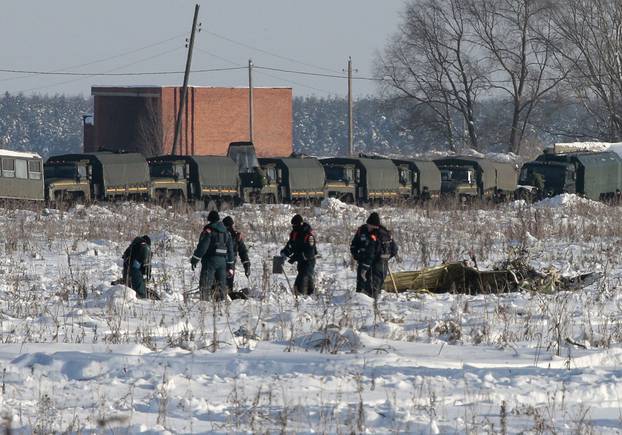 Russian Emergency Situations Ministry members work at the crash site of the short-haul AN-148 airplane operated by Saratov Airlines in Moscow Region