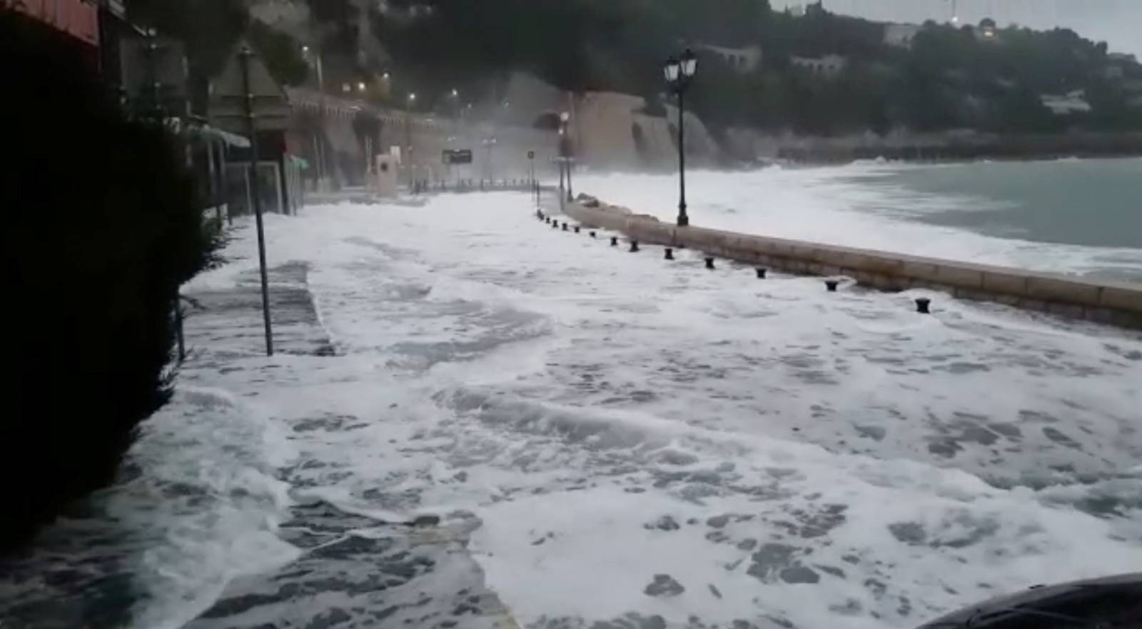 Waves flood the street in Villefranche-Sur-Mer