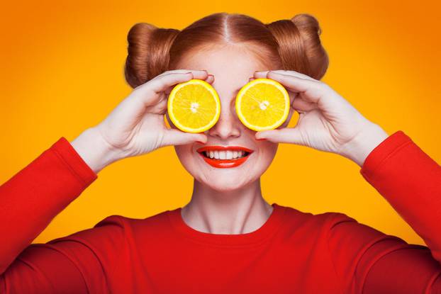 Young beautiful fashion model with Lemon. studio shot.