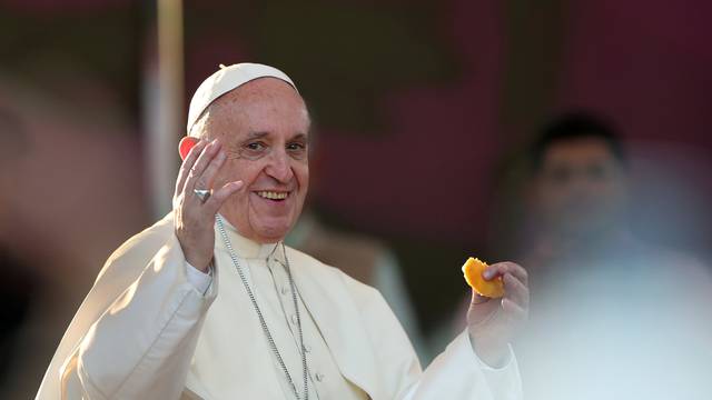 Pope Francis tries a sopaipilla, a typical Chilean pastry, at  the San Alberto Hurtado shrine, in Santiago