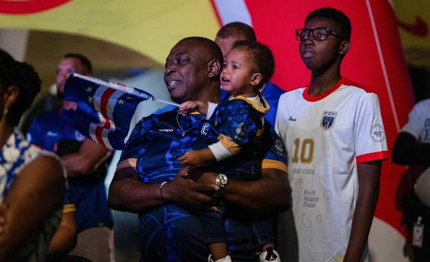 Fans of the Cape Verde national soccer team celebrate as they watch a World Cup group stage match against Uruguay in Praia