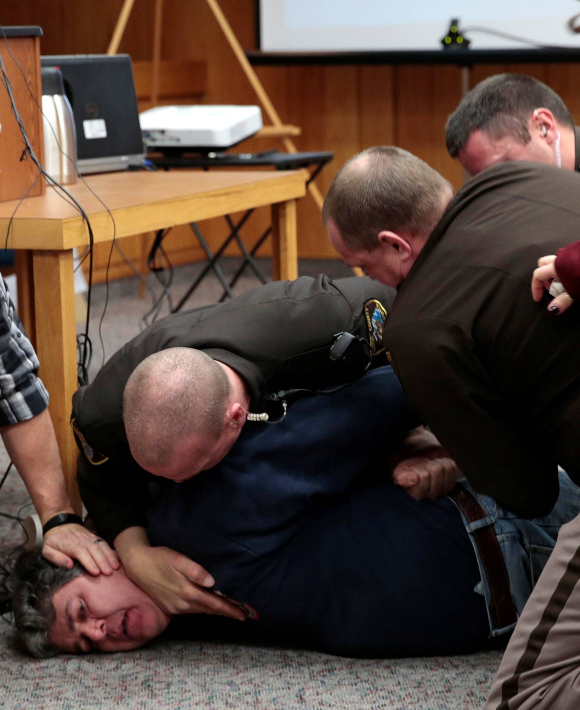 Eaton County Sheriffs restrain Randall Margraves after he lunged at Larry Nassar, during victim statements of his sentencing in the Eaton County Circuit Court in Charlotte