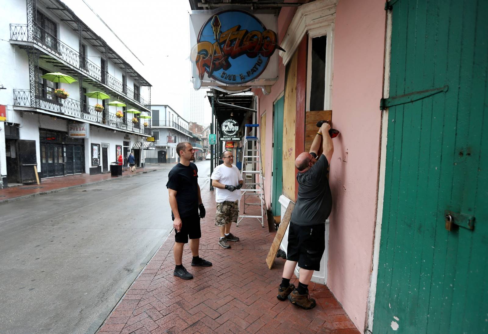 Employees board up a business on Bourbon St. as Tropical Storm Barry approaches land in New Orleans