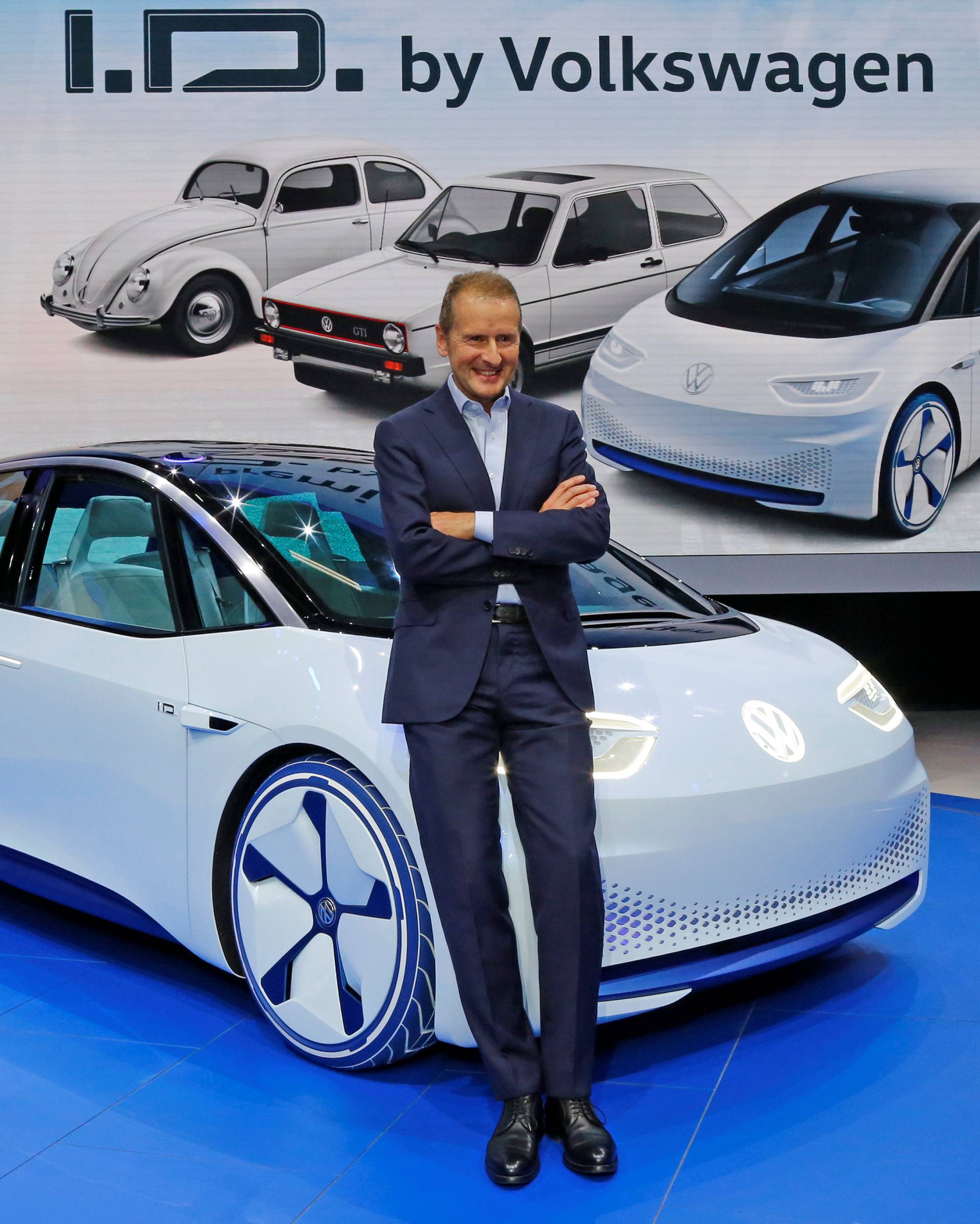 Herbert Diess, head of Volkswagen's namesake brand, poses in front of a Golf electric car on the media day at the Mondial de l'Automobile in Paris