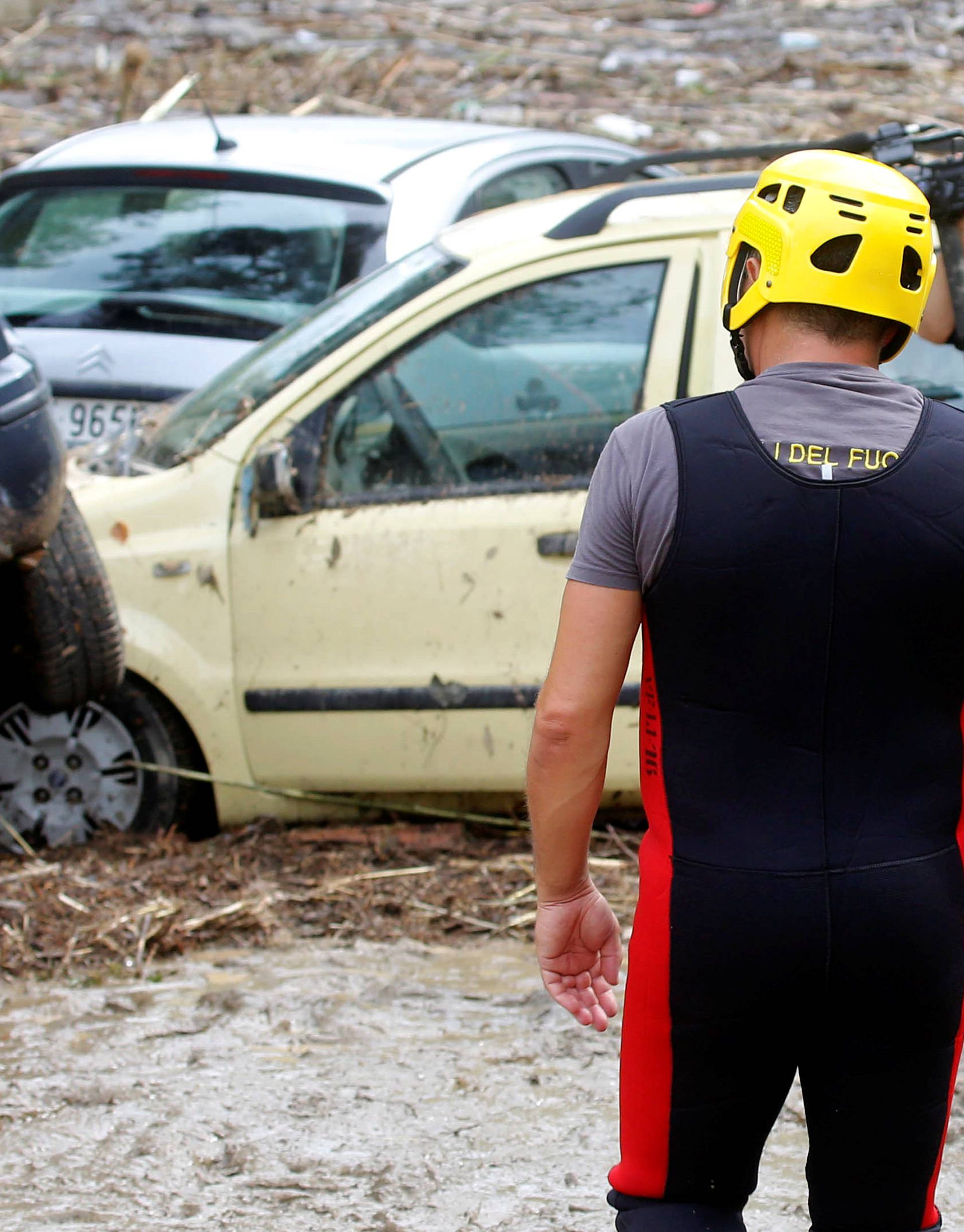 Damaged cars are seen following floods in Livorno