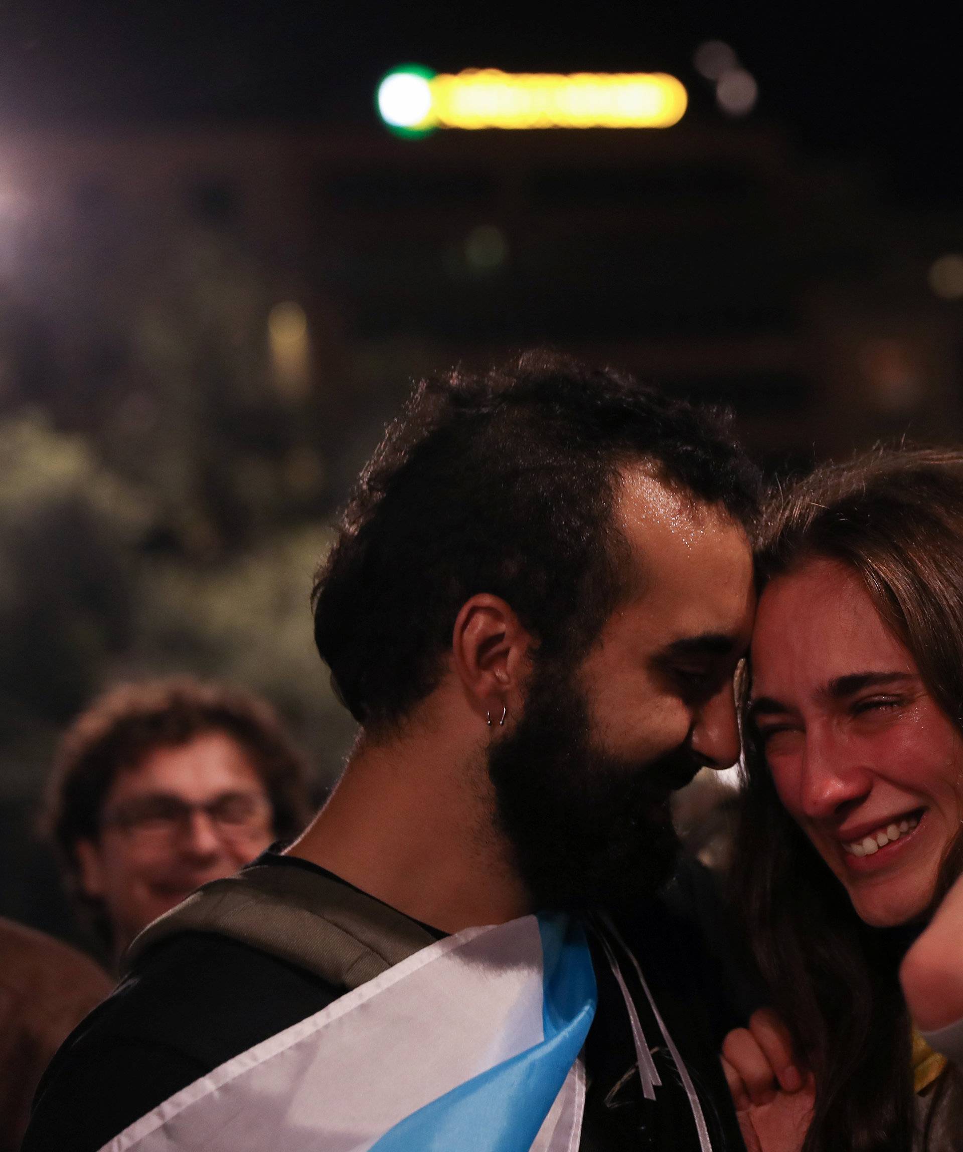 People react as they listen to Catalan president Carles Puigdemont during a gathering at Plaza Catalunya after voting ended for the banned independence referendum, in Barcelona