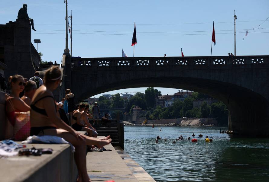 People swim in the Rhine river during a heatwave in Basel
