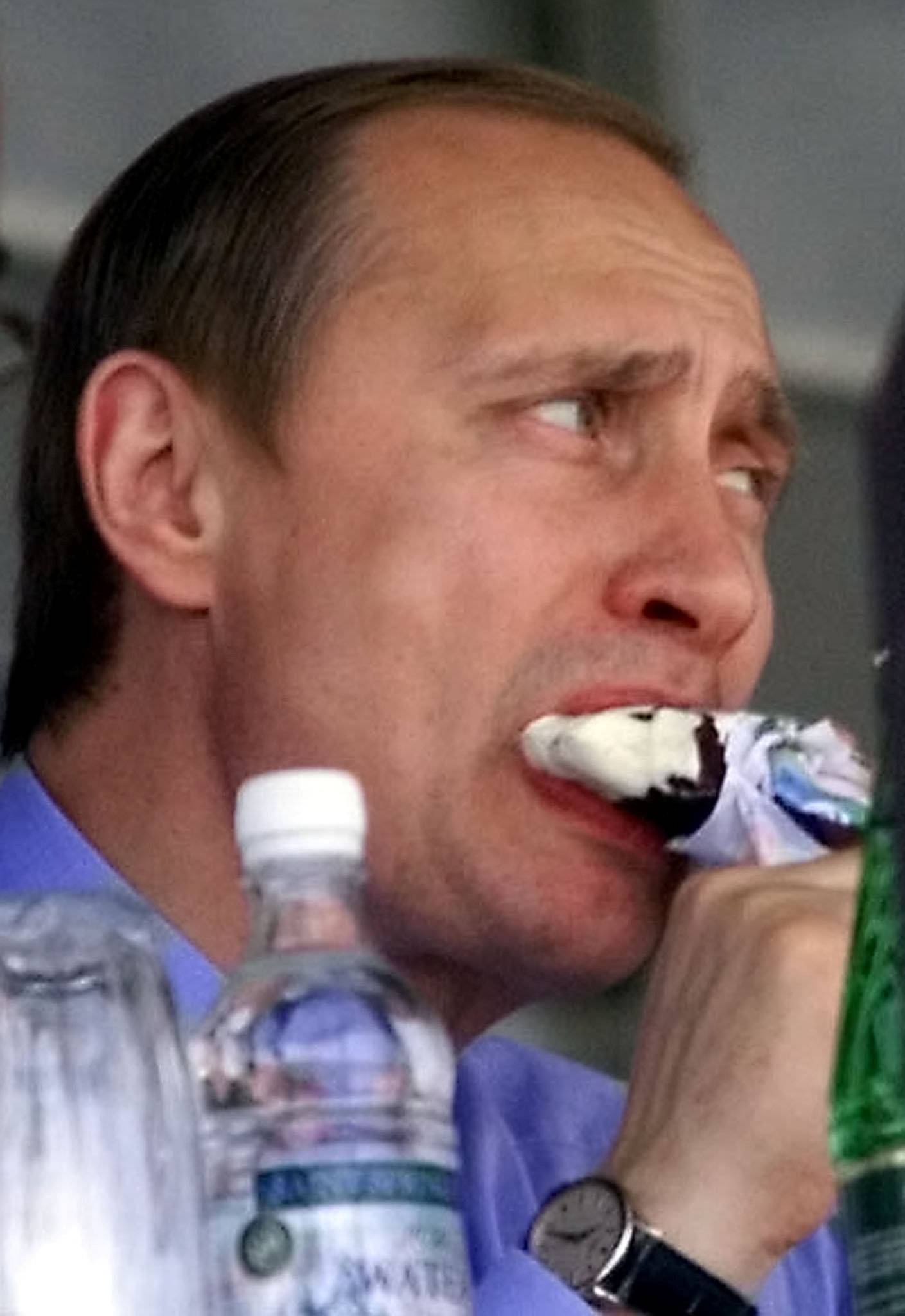FILE PHOTO: Russian President Vladimir Putin eats an ice cream during a visit to a weapons exhibition in Nizhny Tagil