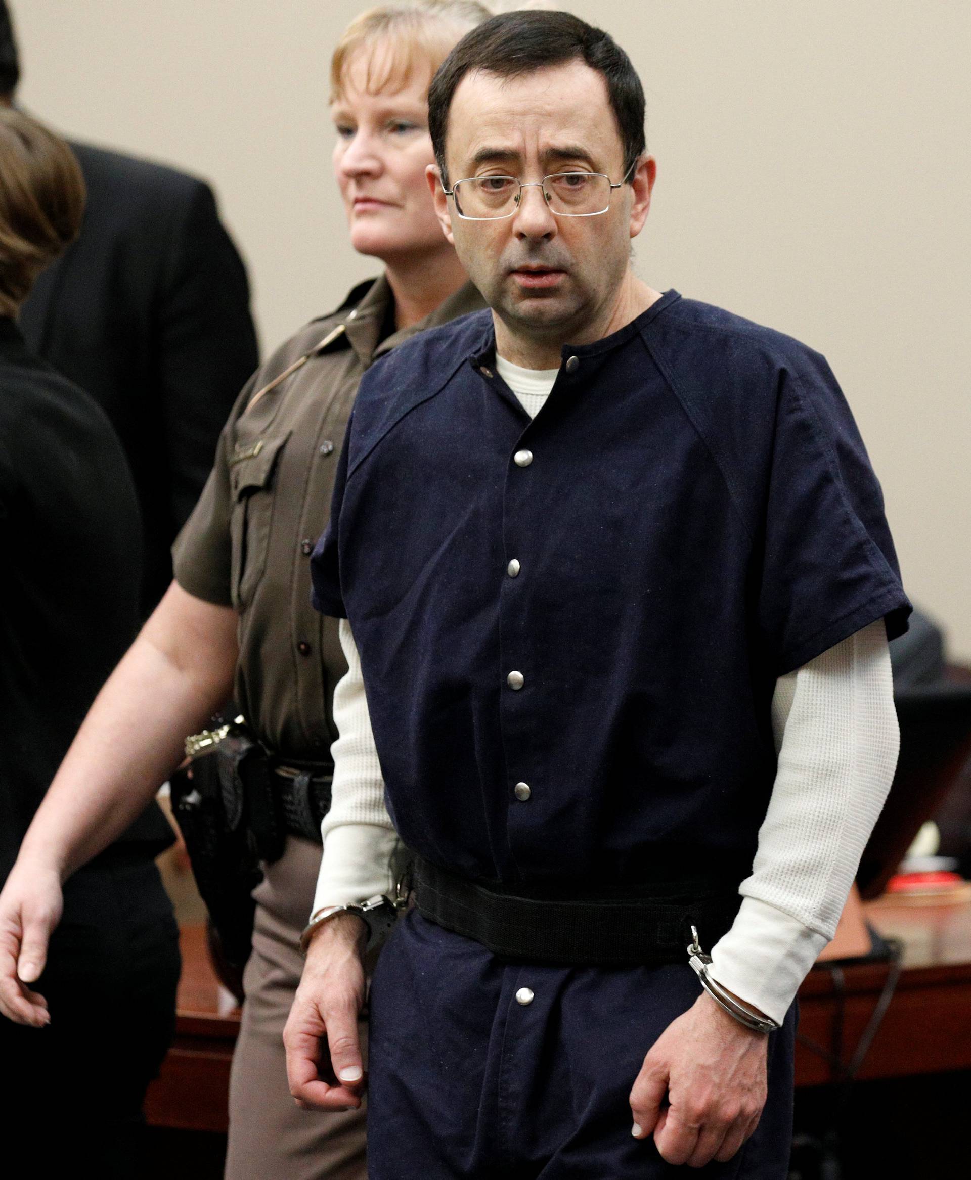 Larry Nassar, a former team USA Gymnastics doctor who pleaded guilty in November 2017 to sexual assault charges, arrives in the courtroom during his sentencing hearing in Lansing