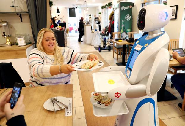 A robot waiter serves customers at a cafe in Budapest
