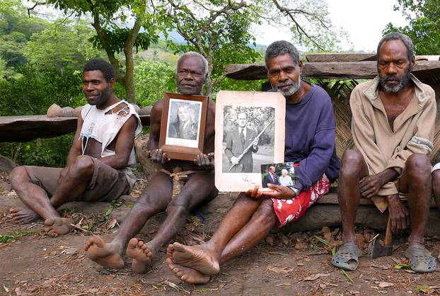 Chief Jack Malia from the Imanourane Tribe holds photographs of Britain