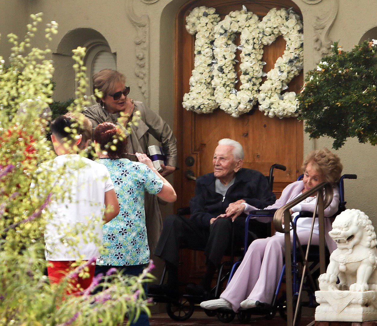 Hollywood Legend Kirk Douglas and wife Anne pose for pictures in front of their house as he celebrates turning 102 in Beverly Hills, Ca