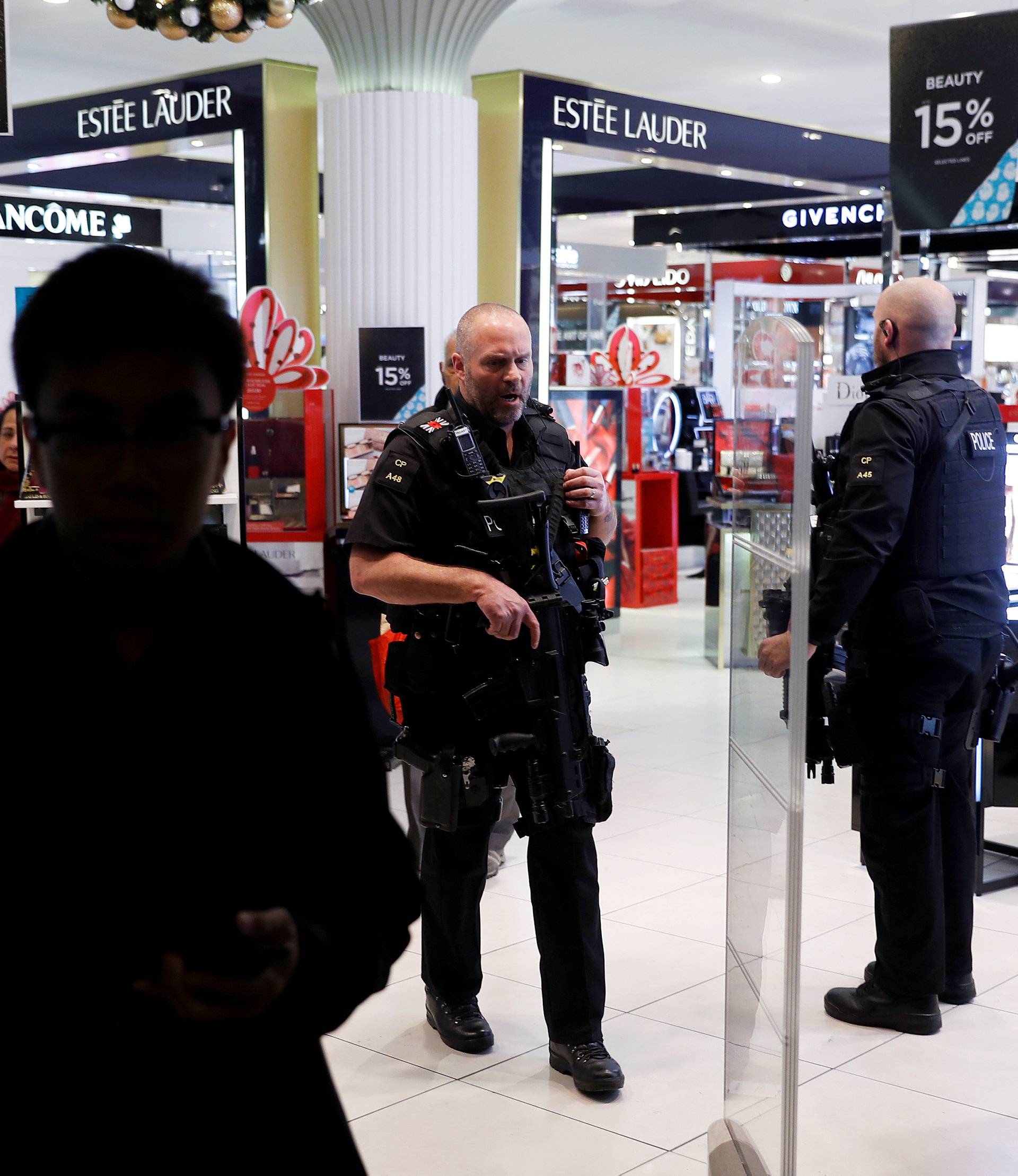 Armed police walk through a department store on Oxford Street, London