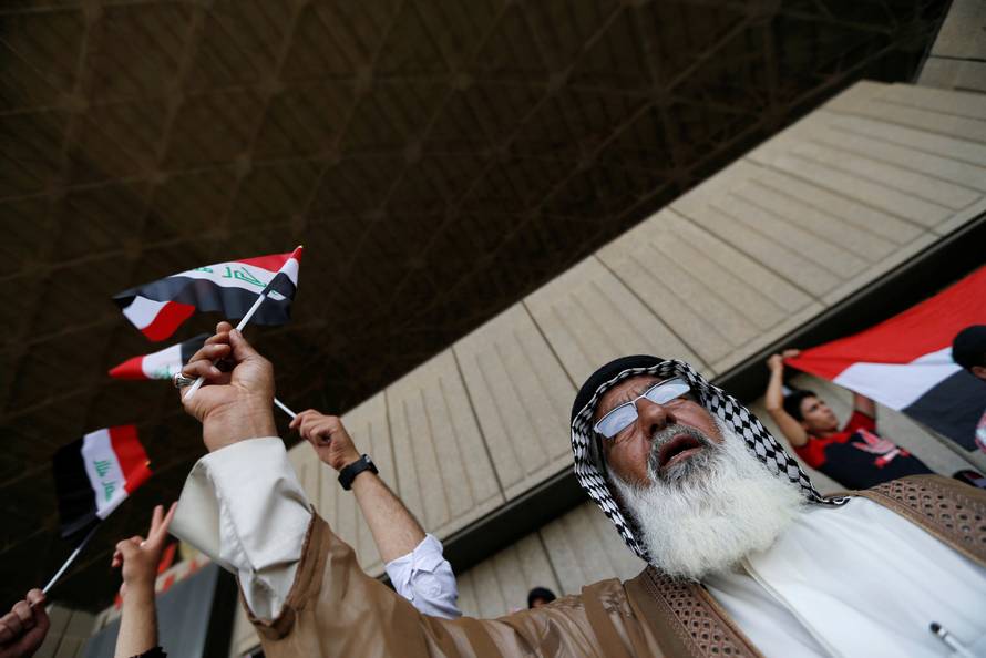 Followers of Iraq's Shi'ite cleric Moqtada al-Sadr shout slogans at Grand Festivities Square within the Green Zone in Baghdad