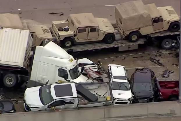 Cars and trucks are wedged together after a morning crash on the ice covered I-35 in Fort Worth