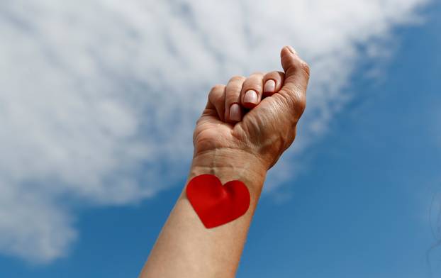 A woman raises her fist during a protest against restrictions in the wedding industry in front of the Brandenburg Gate, following the coronavirus disease (COVID-19) outbreak in Berlin