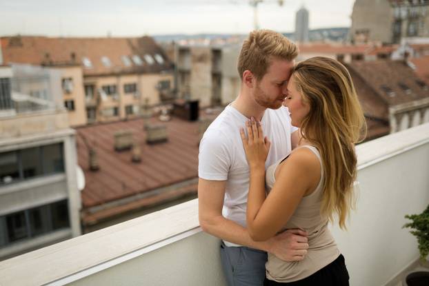 Romantic couple kissing on rooftop