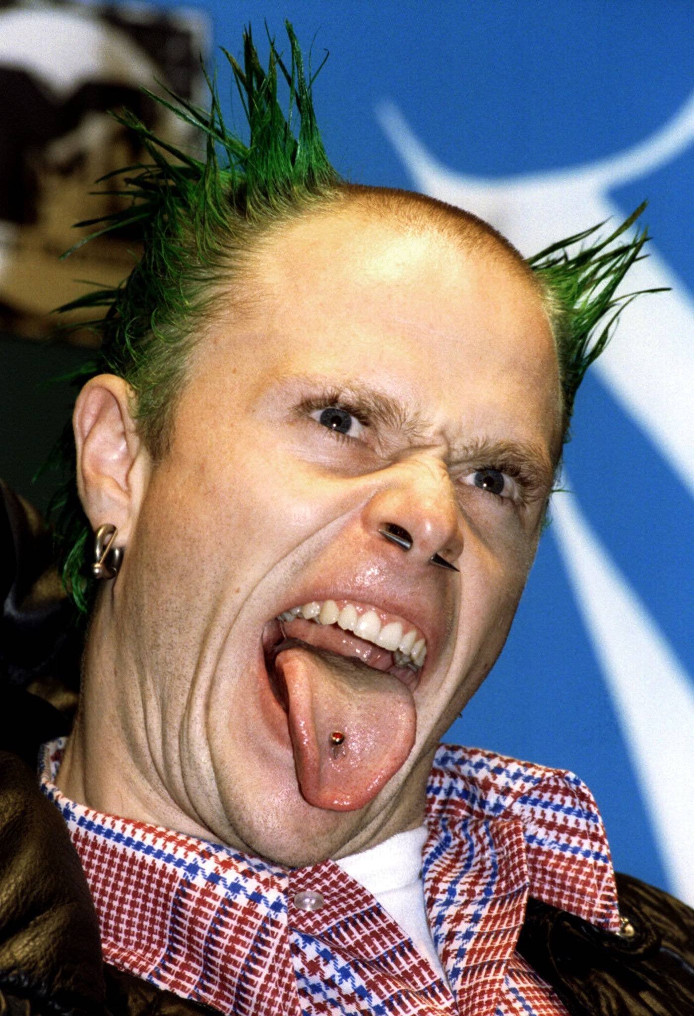 FILE PHOTO: The Prodigy lead singer Keith Flint sticks out his tongue at press photographers during the 1996 MTV Europe Music Awards gala in London