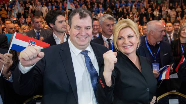 Croatia's President Kolinda Grabar Kitarovic and presidential candidate poses for a picture with her husband Jakov Kitarovic during an election rally at Cibona hall in Zagreb