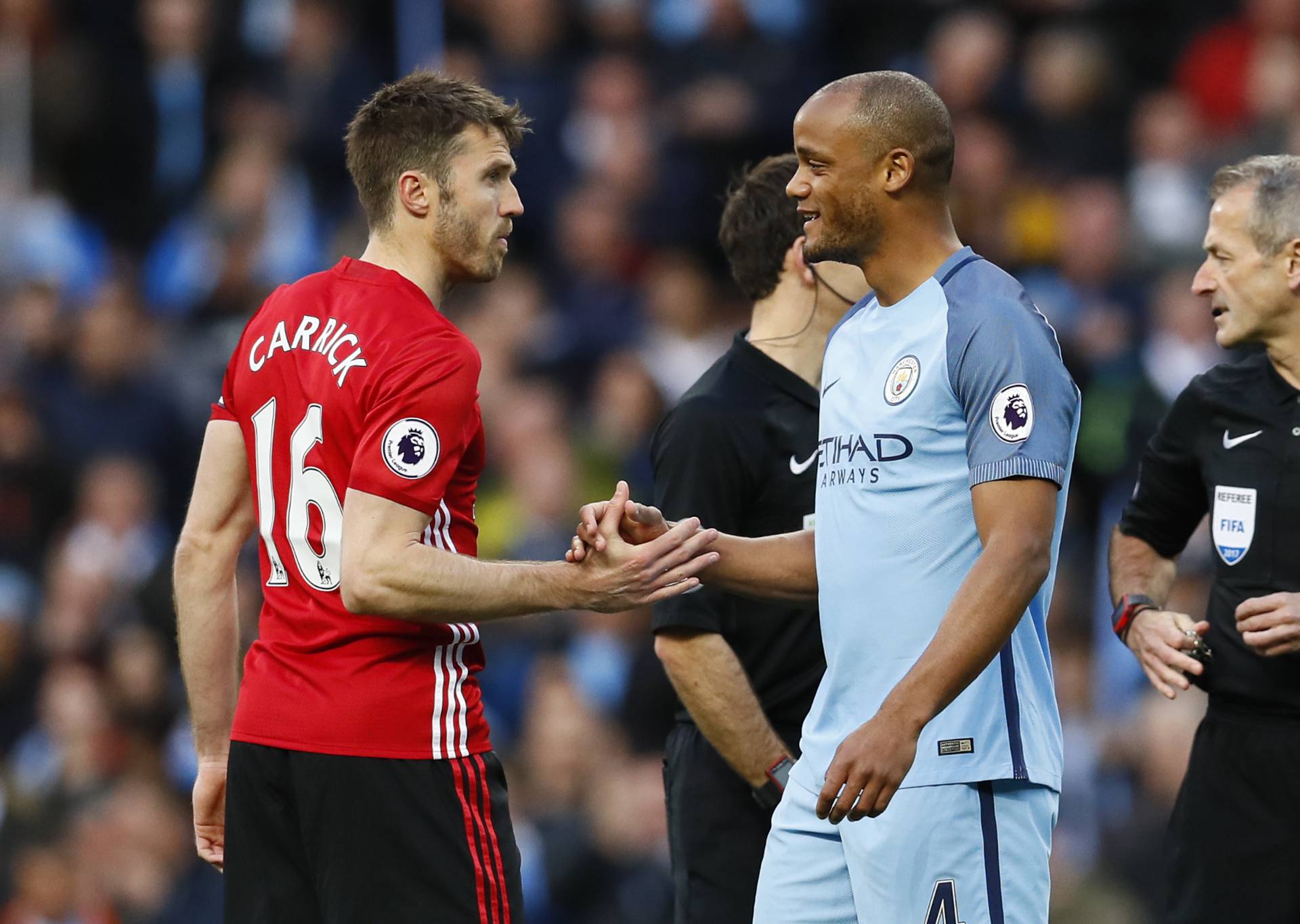 Manchester United's Michael Carrick and Manchester City's Vincent Kompany shake hands before the match