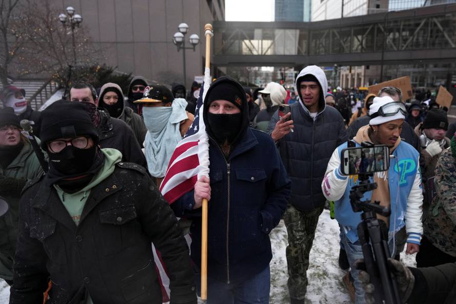 People attend the "March Against Minnesota Fraud" in Minneapolis