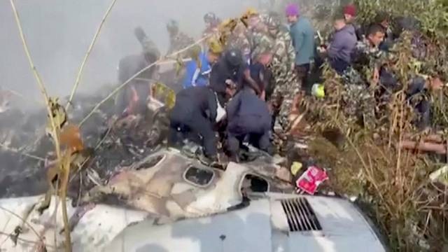 Rescuers work at the site of a plane crash in Pokhara