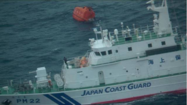 A life boat drifts at sea near the site of a cargo ship that sank off southwestern Japan