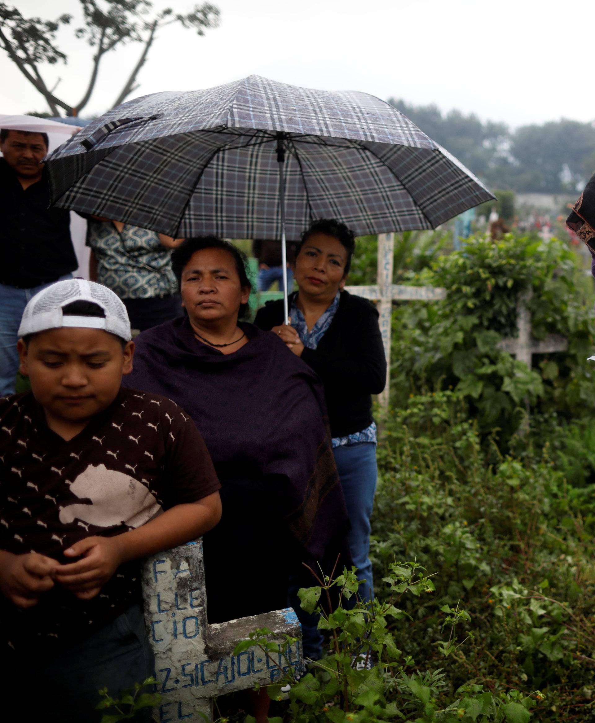 Mourners and relatives participate in the funeral of Juan Fernando Galindo, member of the National Coordinator for Disasters Reduction (CONRED), in Alotenango