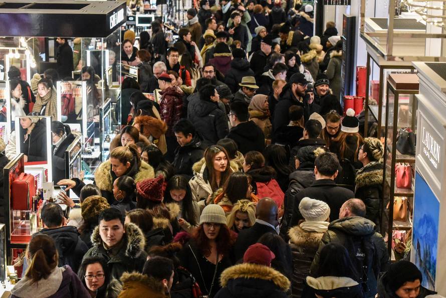 A large crowd of people shop during a Black Friday sales event at Macy's flagship store in New York City