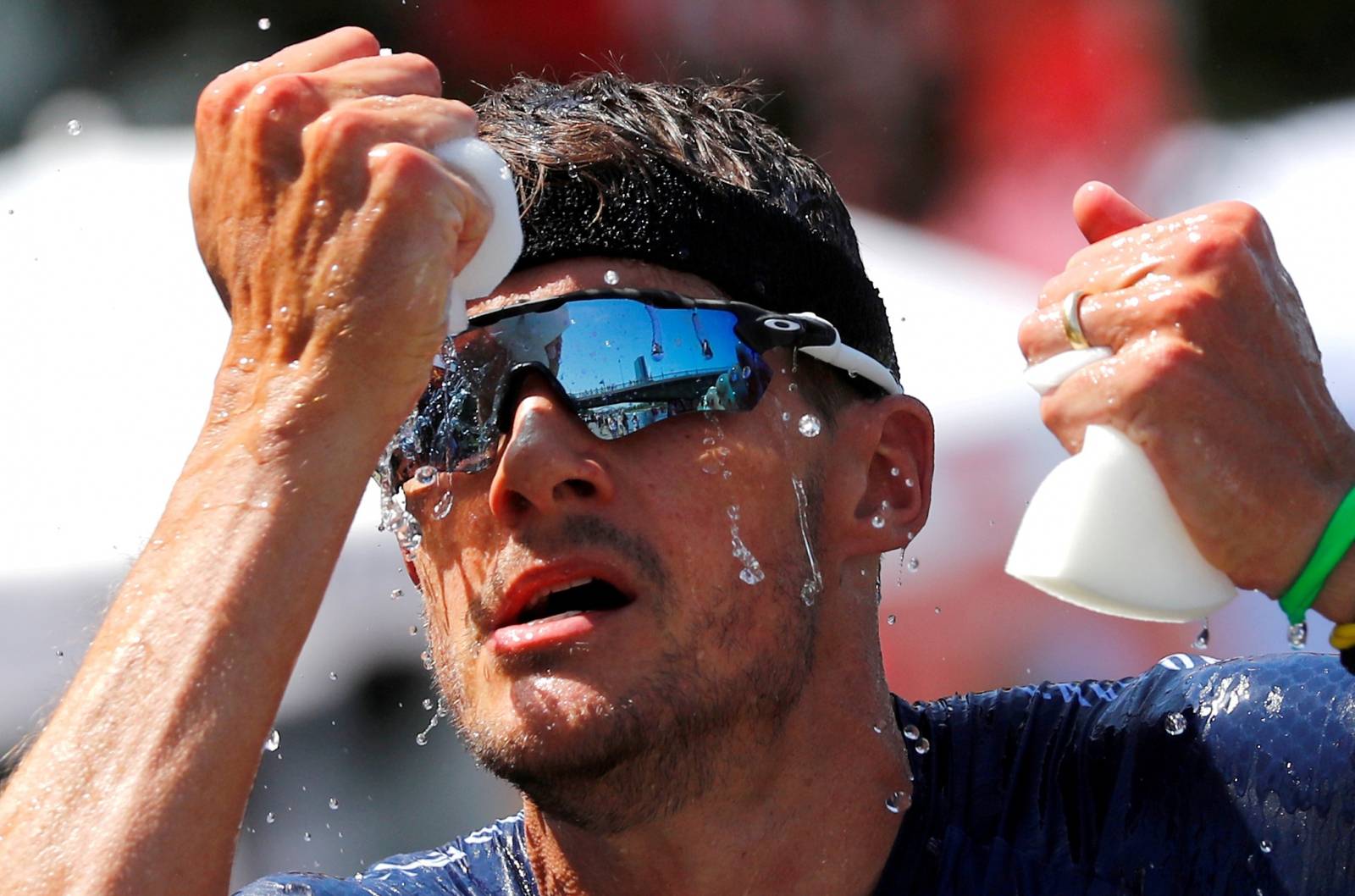 FILE PHOTO: Triathlete Jan Frodeno of Germany tries to cool down on his way to win the Ironman triathlon European Championships in Frankfurt