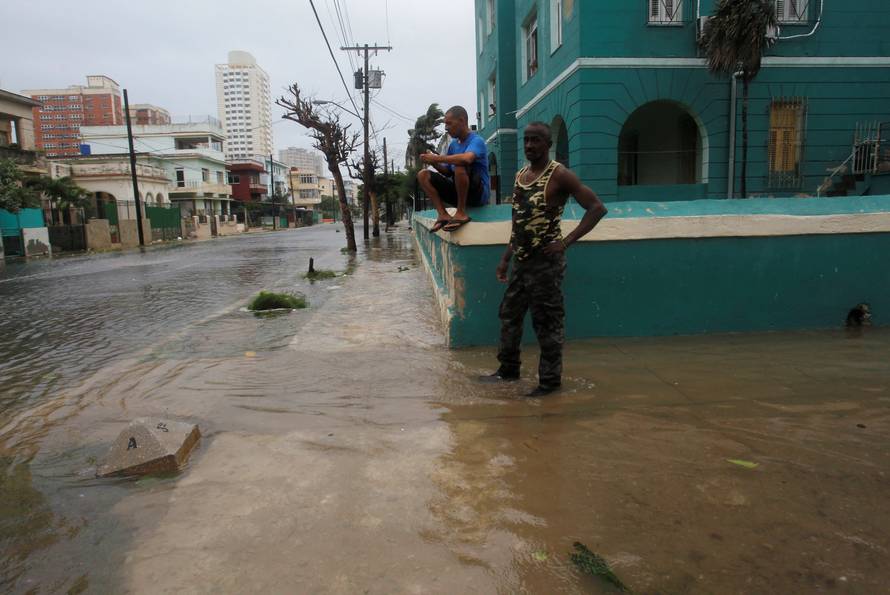 People are seen on a flooded street as Hurricane Irma turns toward the Florida Keys on Saturday, in Havana