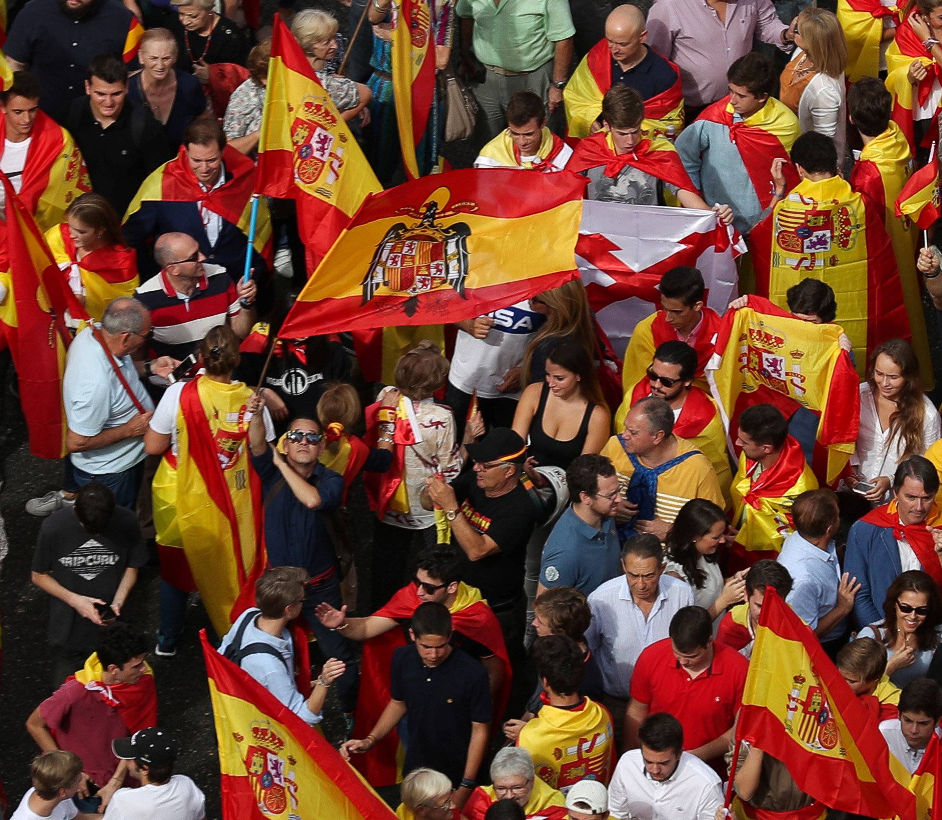 A demonstrator waves a pre-constitutional Spanish flag in front of city hall during a demonstration in favor of a unified Spain a day before the banned October 1 independence referendum, in Madrid