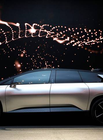 A Faraday Future FF 91 electric car is displayed on stage during an unveiling event at CES in Las Vegas