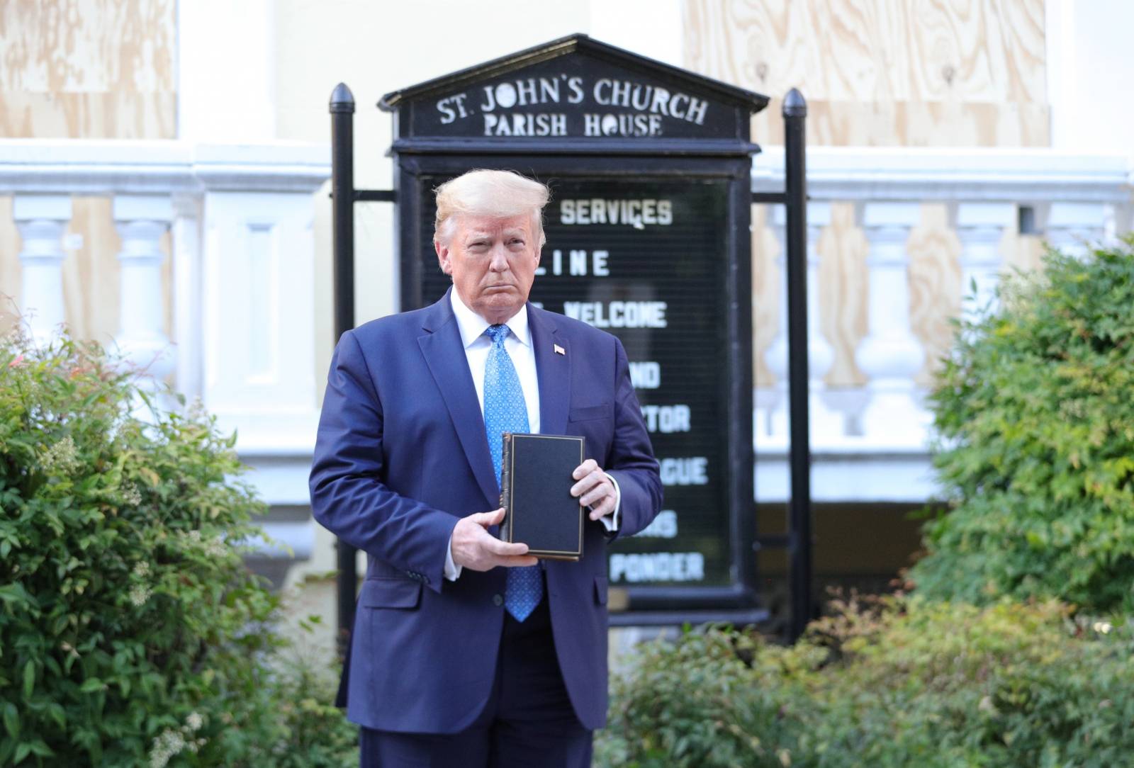 U.S. President Trump holds up Bible during photo opp in front of St John's Church in Washington