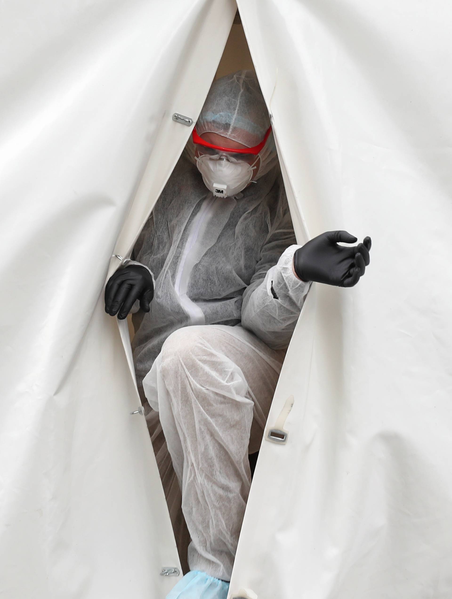 A medical specialist walks out of a mobile laboratory carrying out tests to detect the coronavirus disease in Moscow