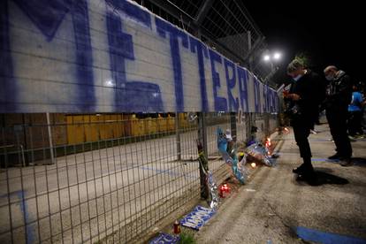 People gather to mourn the death of Argentine soccer legend Diego Maradona outside San Paolo stadium in Naples