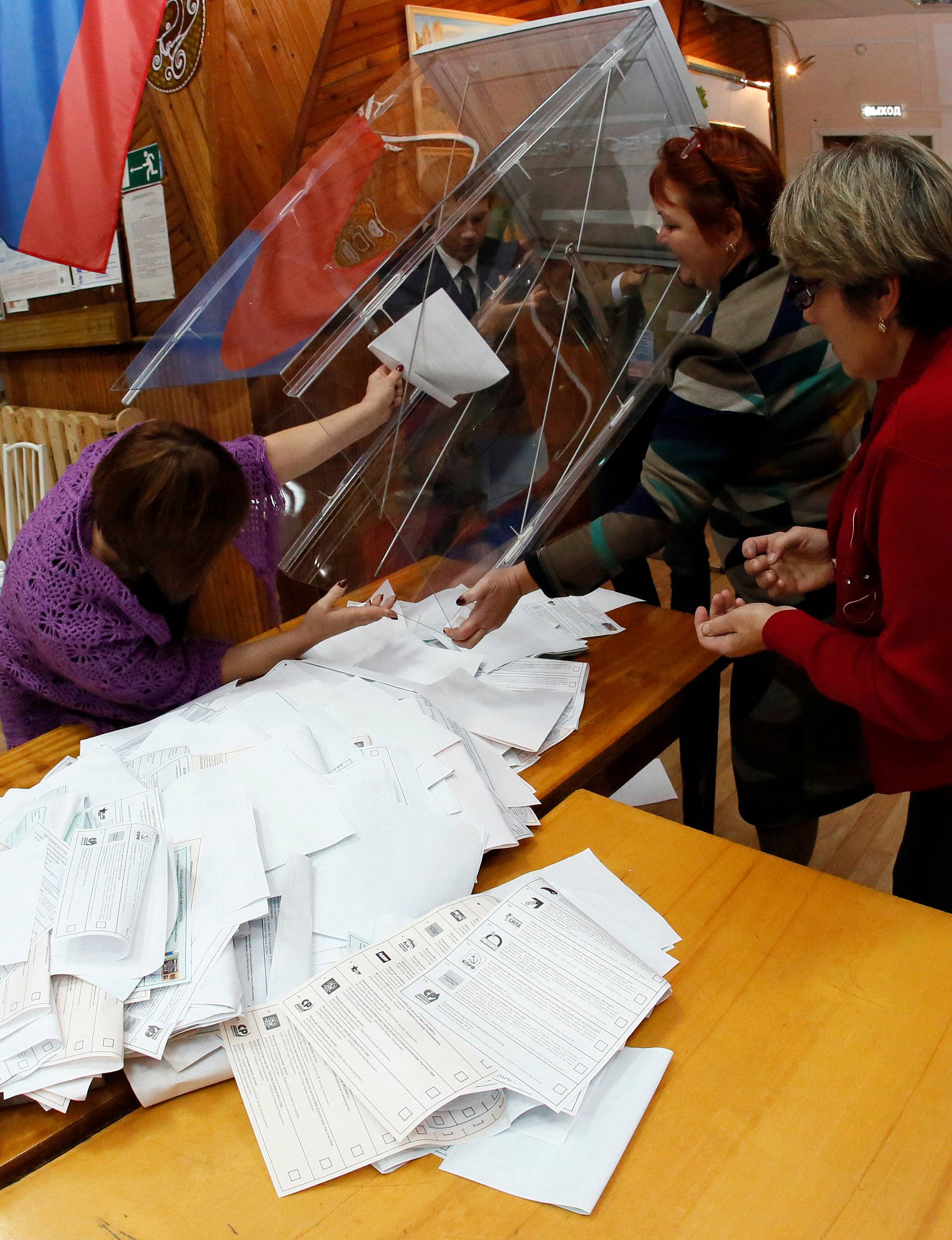 Members of local election commission empty ballot box as they start counting votes during parliamentary election in Ust-Mana outside Krasnoyarsk