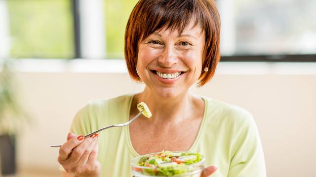 Older woman with healthy food indoors