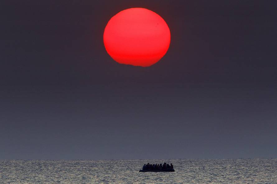 Syrian refugees on a dinghy drift in the Aegean sea off the Greek island of Kos in Greece 