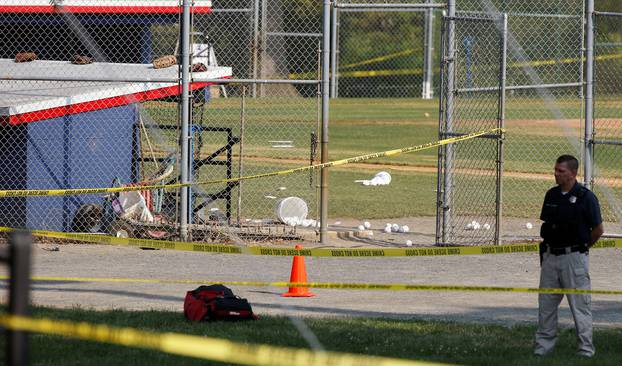 A police officer guards the shooting scene after a gunman opened fire on Republican members of Congress during a baseball practice in Alexandria, Virginia