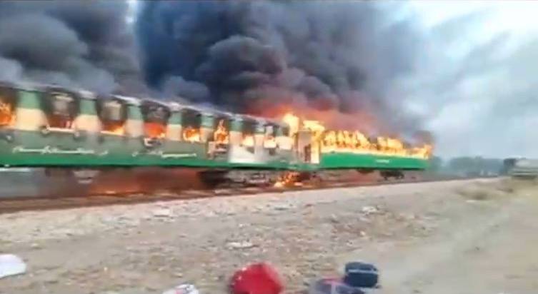 Video grab of a fire burning in a train carriage after a gas canister passengers were using to cook breakfast exploded, near the town of Rahim Yar Khan