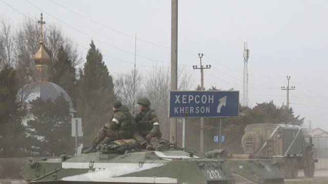 Russian Army military vehicle drives along a street in Armyansk