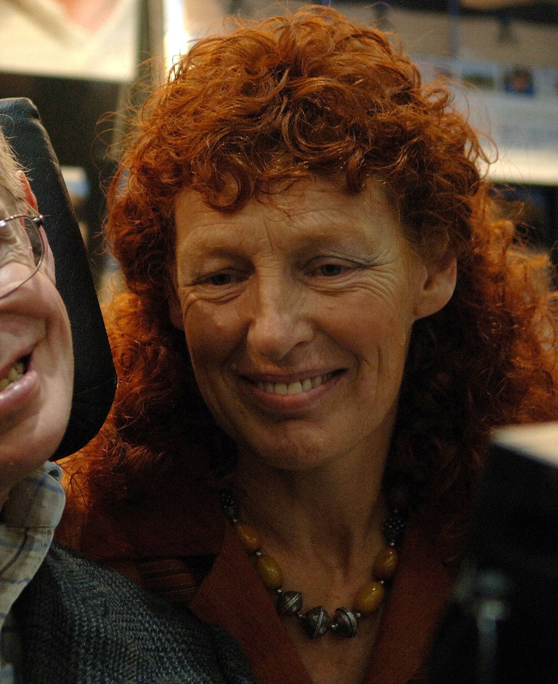 FILE PHOTO: British astrophysicist Professor Stephen Hawking and his wife Elaine (R) visit the stand of German bookseller Rowohlt at the Frankfurt book fair