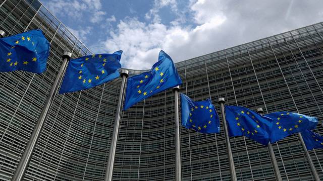 FILE PHOTO: European Union flags flutter outside the European Commission headquarters in Brussels