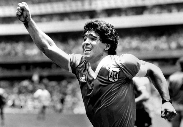 FILE PHOTO:  Argentinian star Diego Maradona raises his arm in the air after scoring