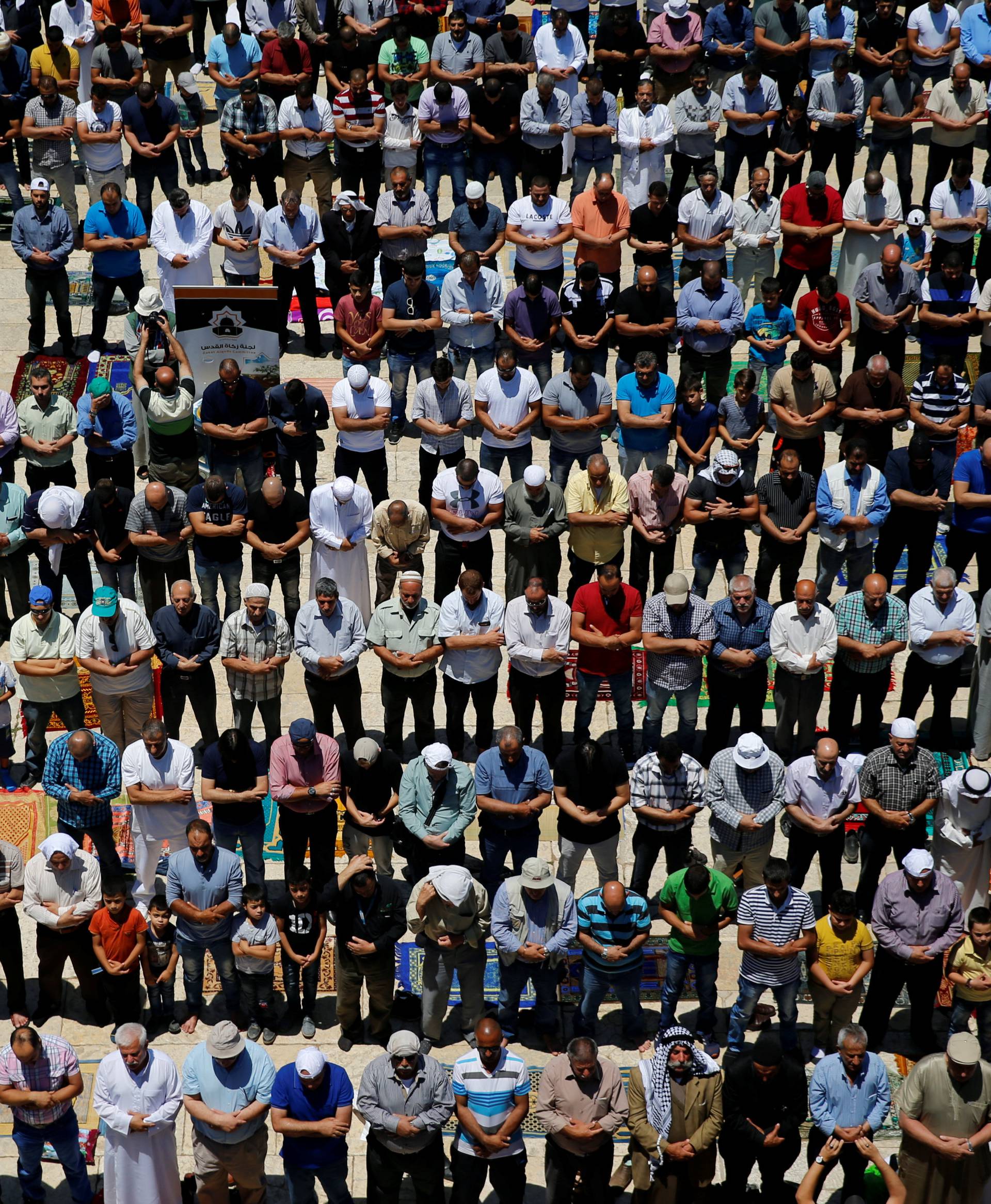 Palestinian men prays on the first Friday of the holy fasting month of Ramadan on the compound known to Muslims as Noble Sanctuary and to Jews as Temple Mount in Jerusalem's Old City