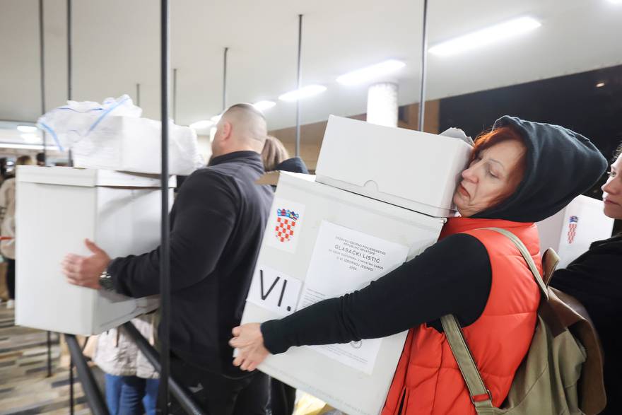 Red ispred Državnog izbornog povjerenstva, ljudi stoje s kutijama biračkih listića