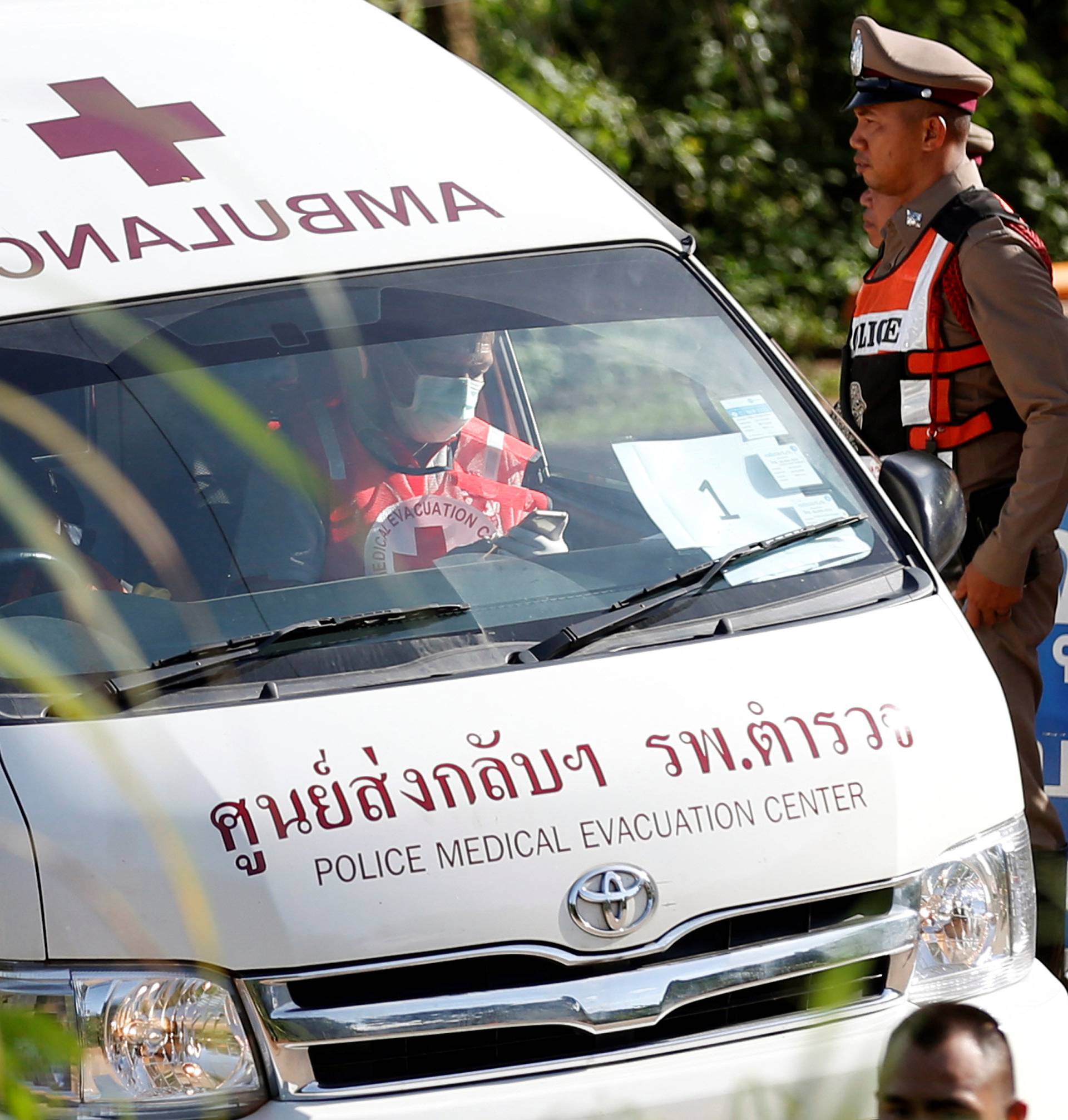 An ambulance believed to be carrying rescued schoolboys leaves from Tham Luang cave complex in the northern province of Chiang Rai