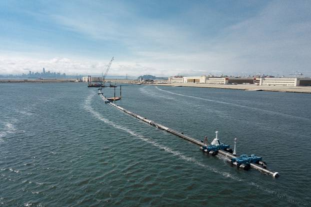 System 001, an ocean cleanup system that aims at removing plastic from the ocean, on the final day of the attachment of the screen in the water in Alameda
