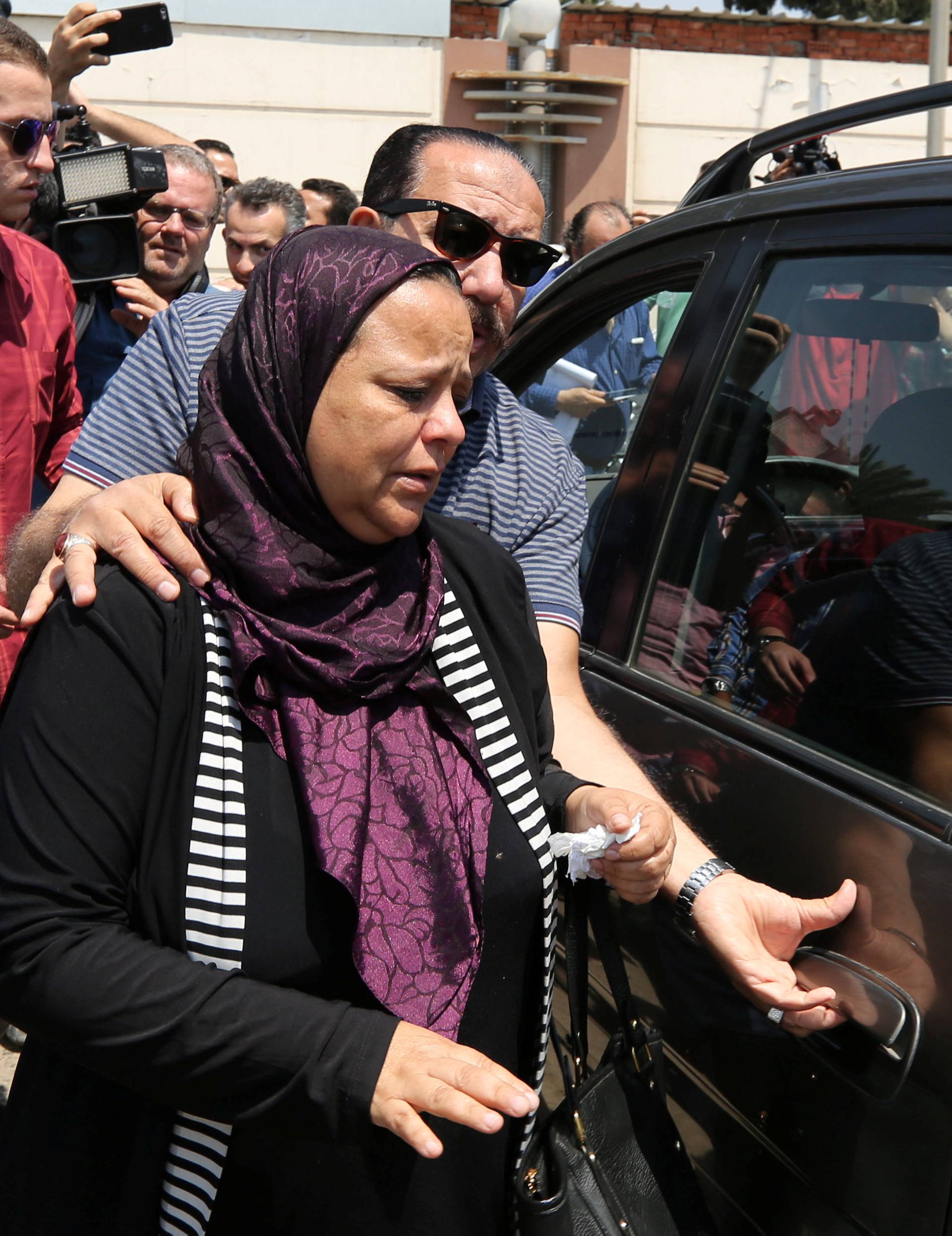 Unidentified relatives and friends of passengers who were flying in an EgyptAir plane that vanished from radar en route from Paris to Cairo react as they wait outside the Egyptair in-flight service building where relatives are being held at Cairo